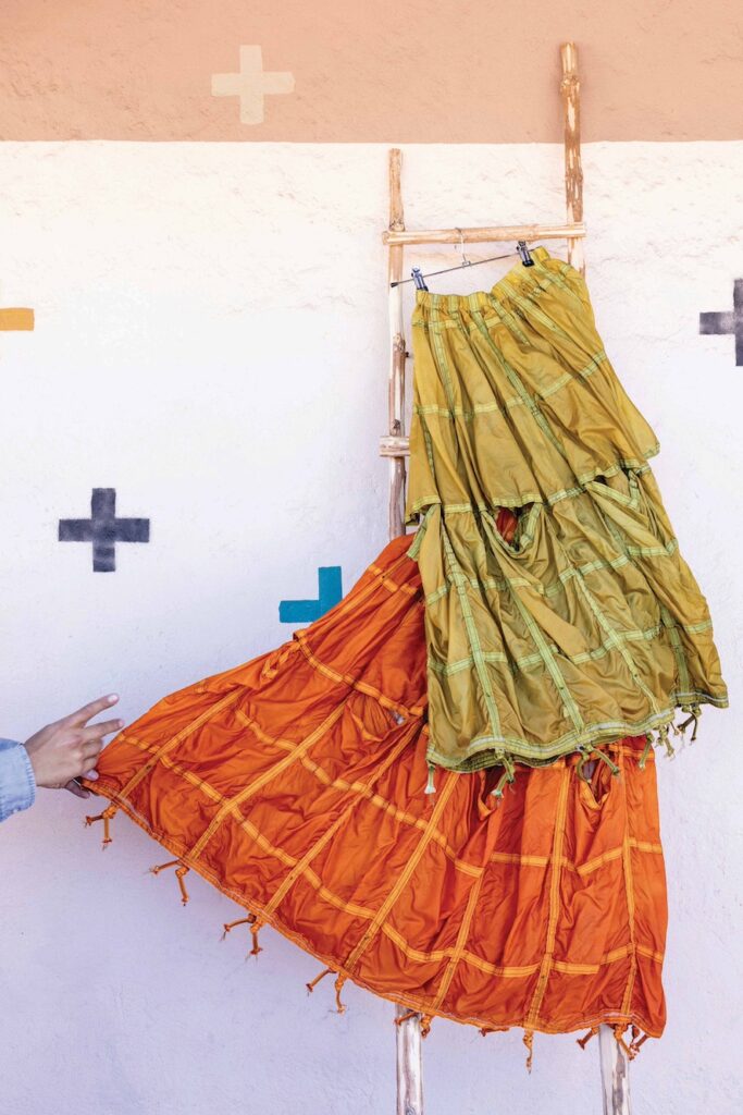 View of colorful fabric against clay way outside