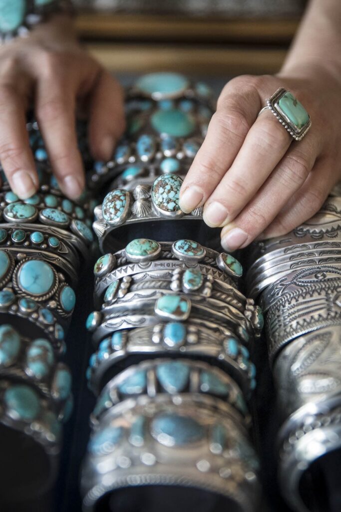 Woman's hands over turquoise jewelry