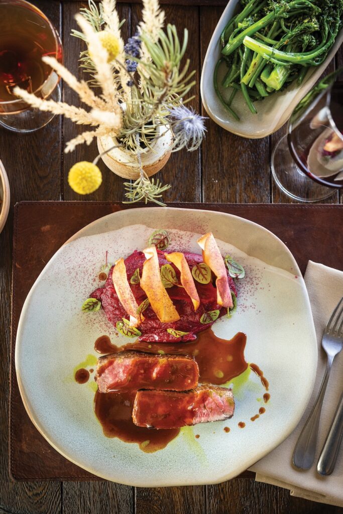 Overhead image of a meal alongside some flowers and vegetables